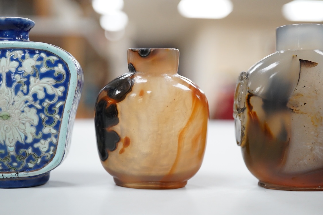 Three 19th century Chinese agate snuff bottles and a porcelain snuff bottle, largest 6cm high (4)